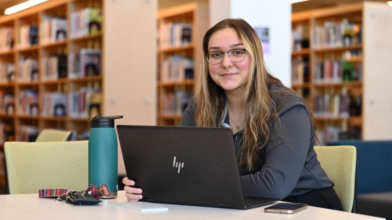 Student Madison Norvell studying on her laptop in Miner Memorial library