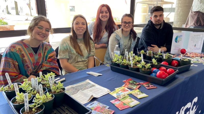 AG Hort Club Assocation with small plants and tomatoes on the table.